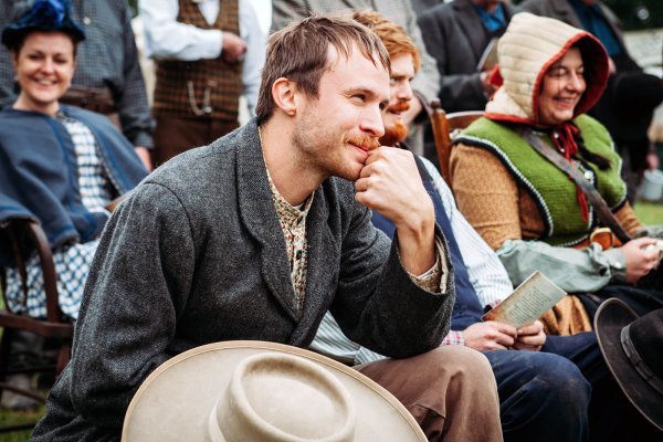 Man sitting and smiling at an event