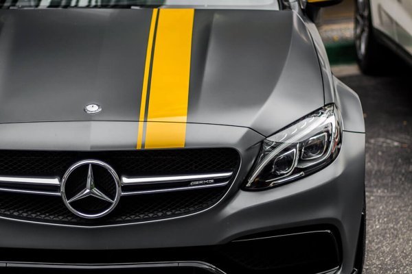 A car parked in a parking lot, showcasing its sleek design and alloy wheels.